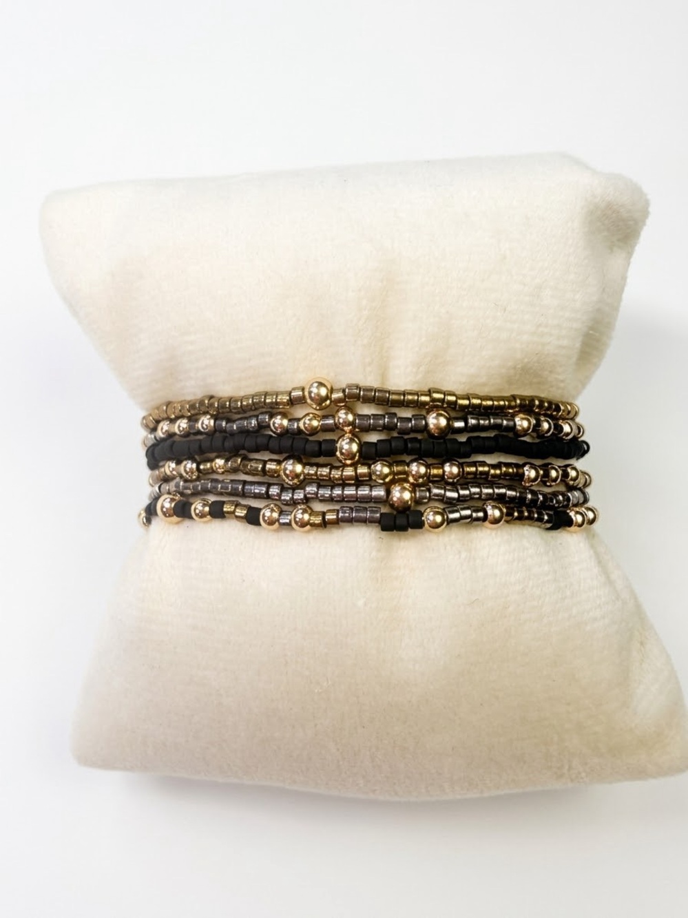 6 ENewton themed black, gold, and silver bracelet stack